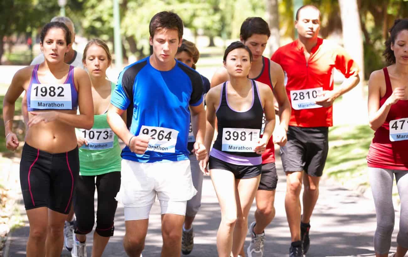 A group of marathoner runners looking tired. 