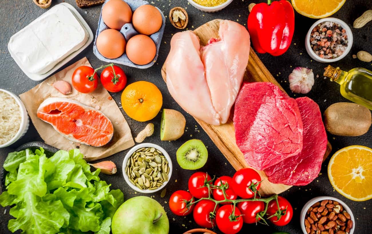 A spread of a healthy diet including chicken, meat, fruits, vegetables, and healthy fats. 