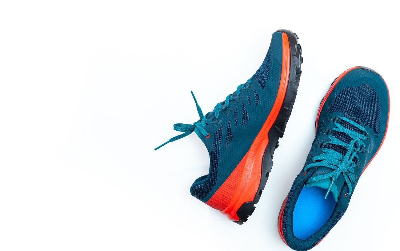 A pair of dark blue and orange running shoes.