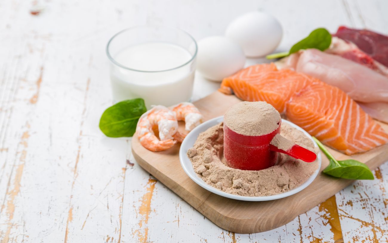 A variety of high-protein foods such as eggs, fish, milk, and protein powder.