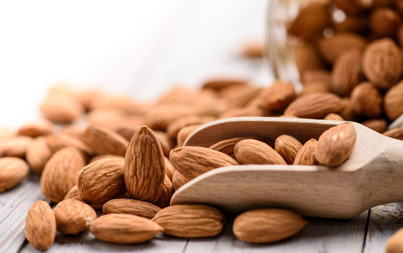 A scoop overflowing with almonds.