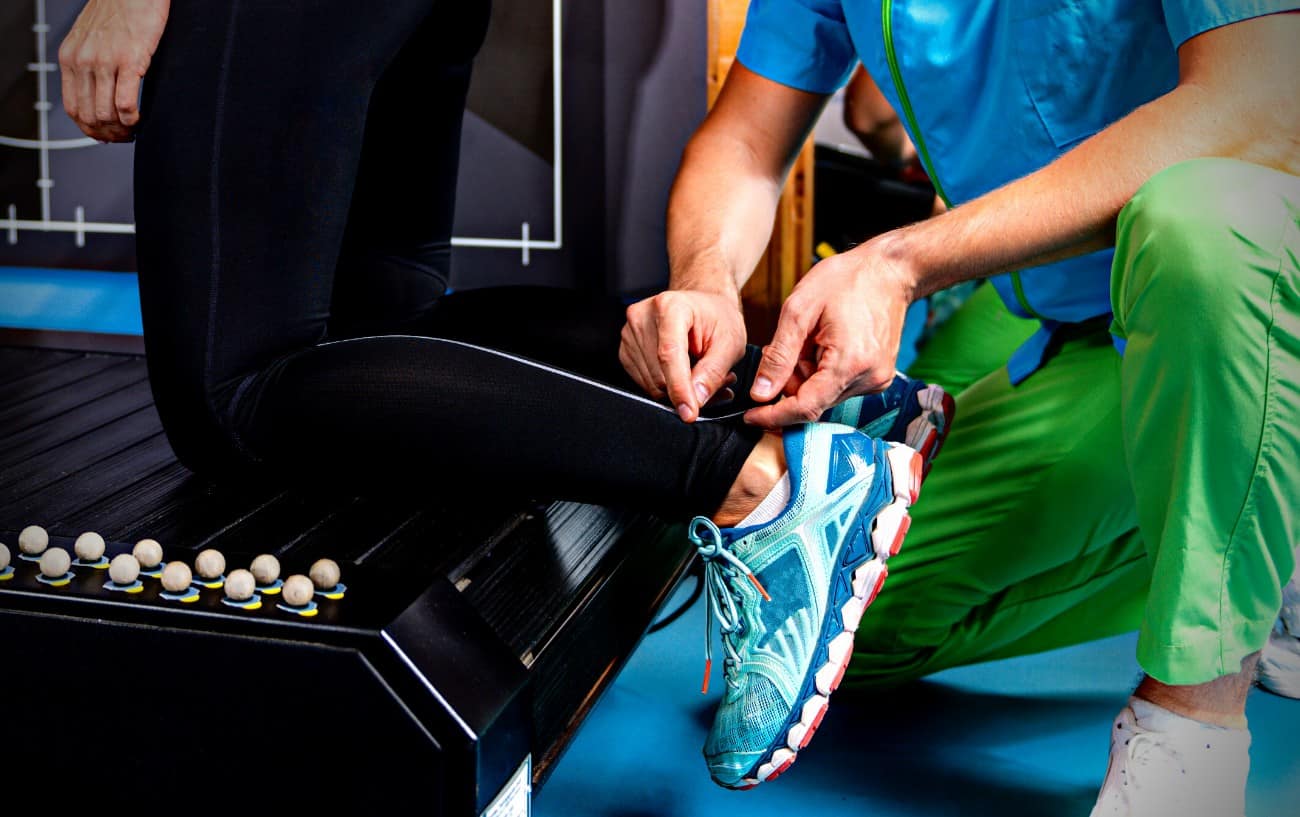 A person getting a running gait analysis where they are putting on sensors.