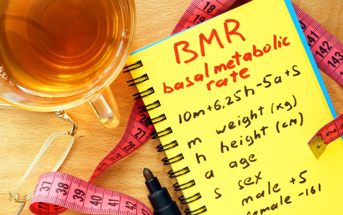 A notebook that says BMR, a calculation and factors.