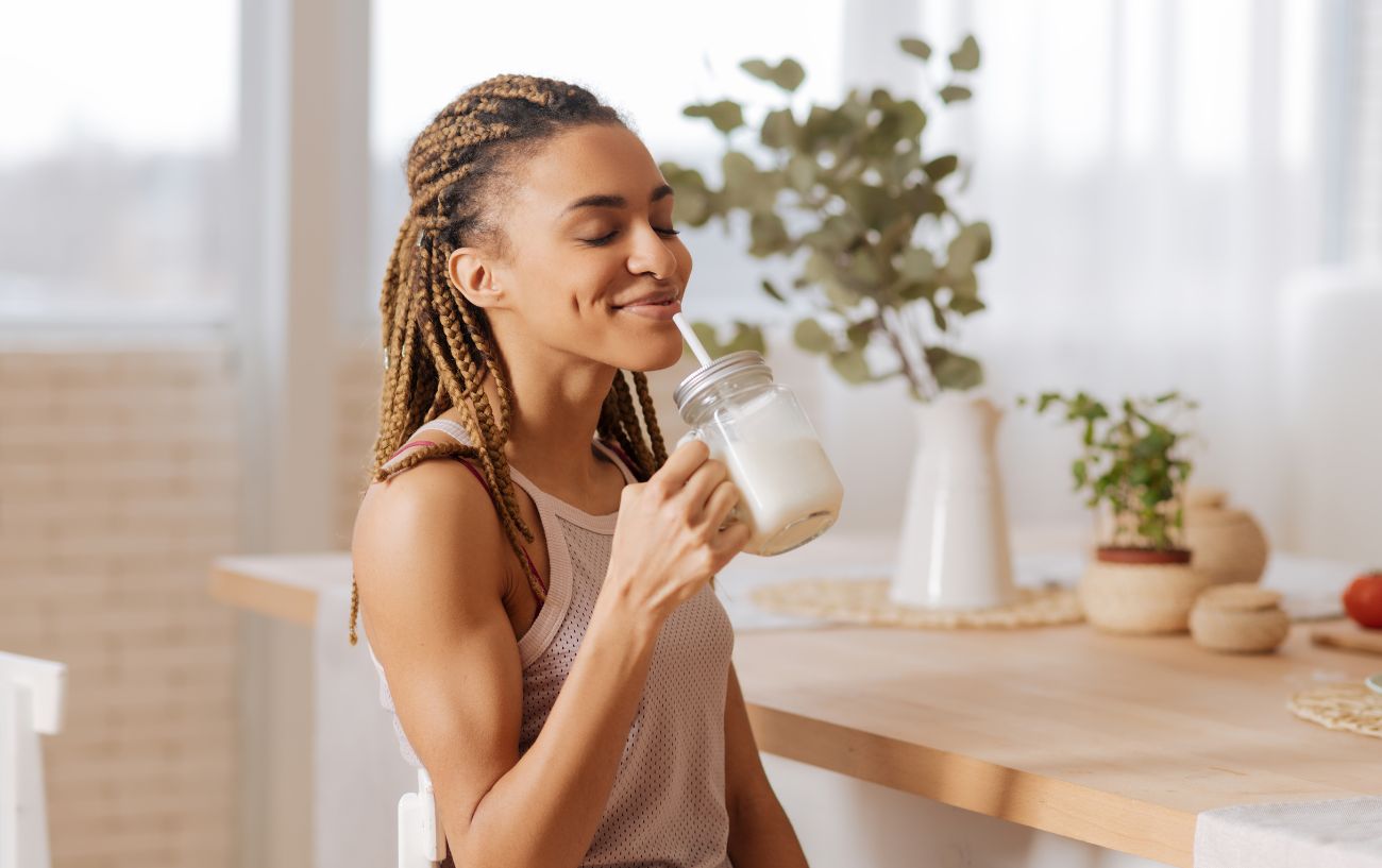A person enjoying her homemade protein shake. 
