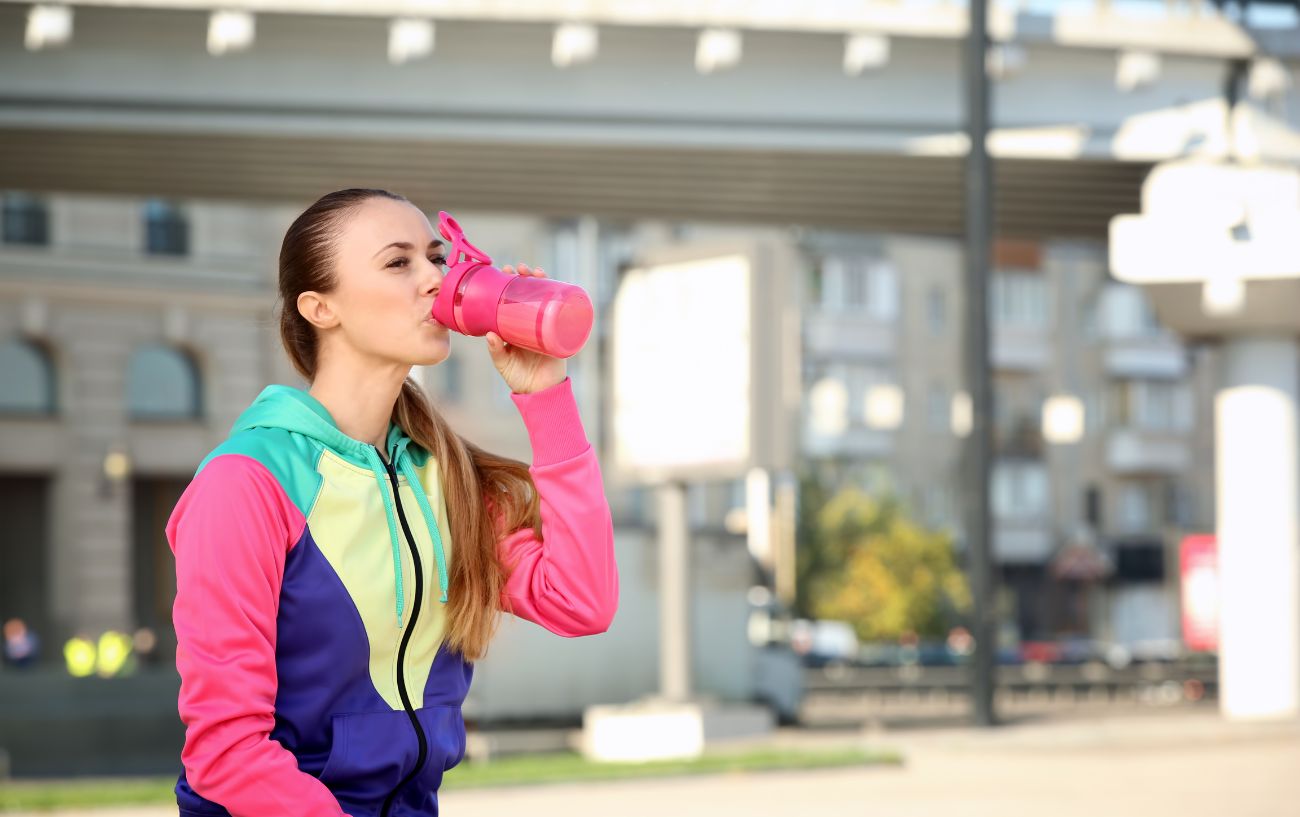 A runner drinking a protein shake after the marathon.