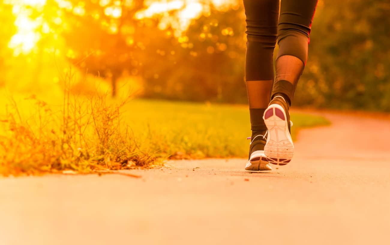a person running along a path in a park