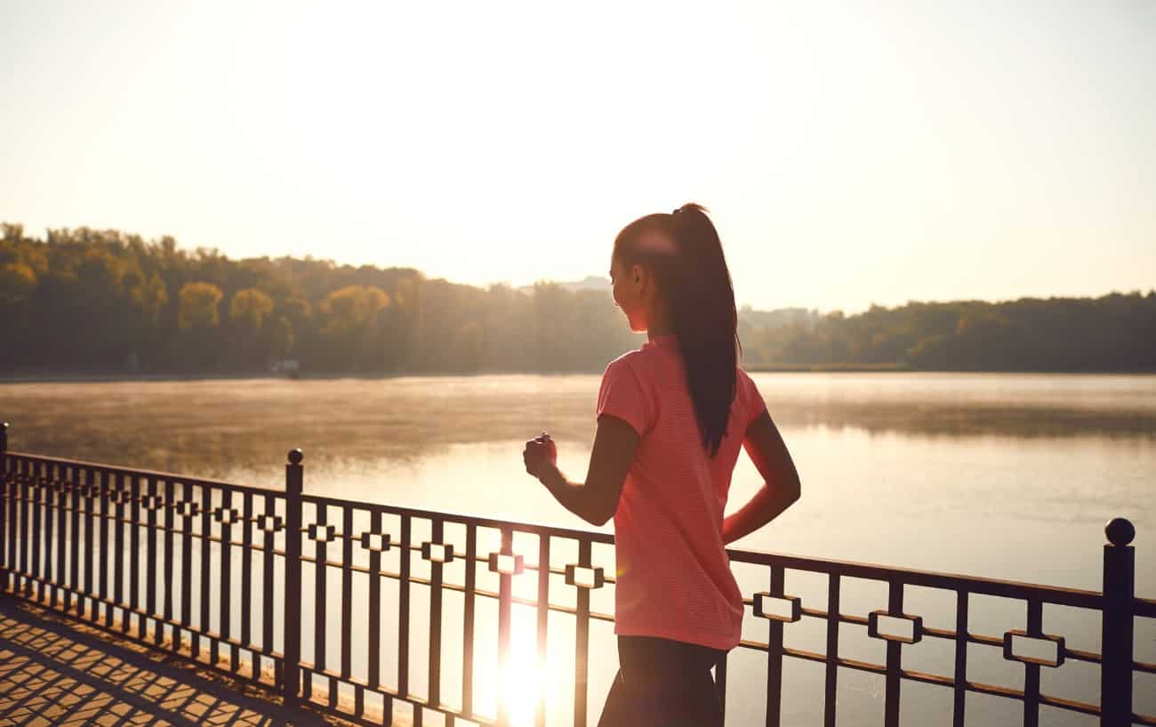 a person running next to a lake