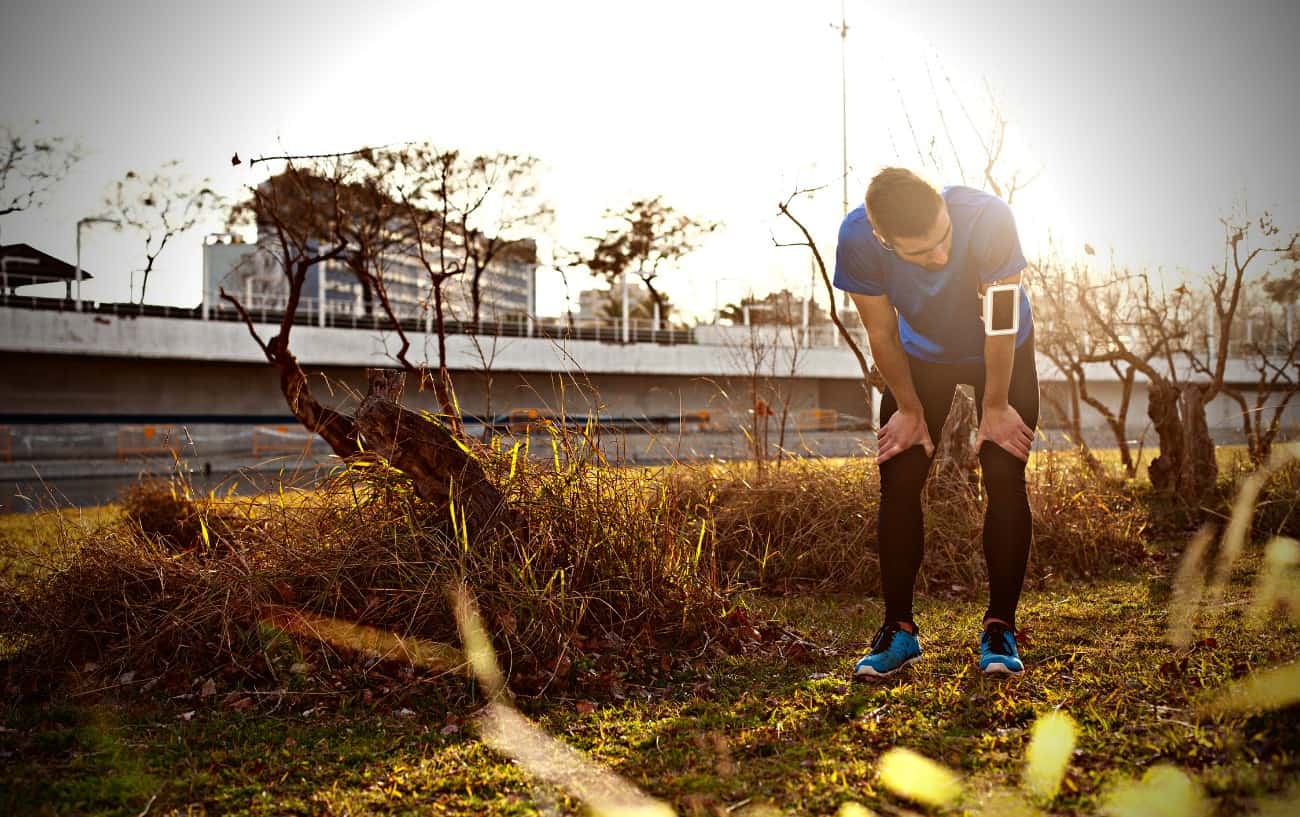 An exhausted runner bent over.