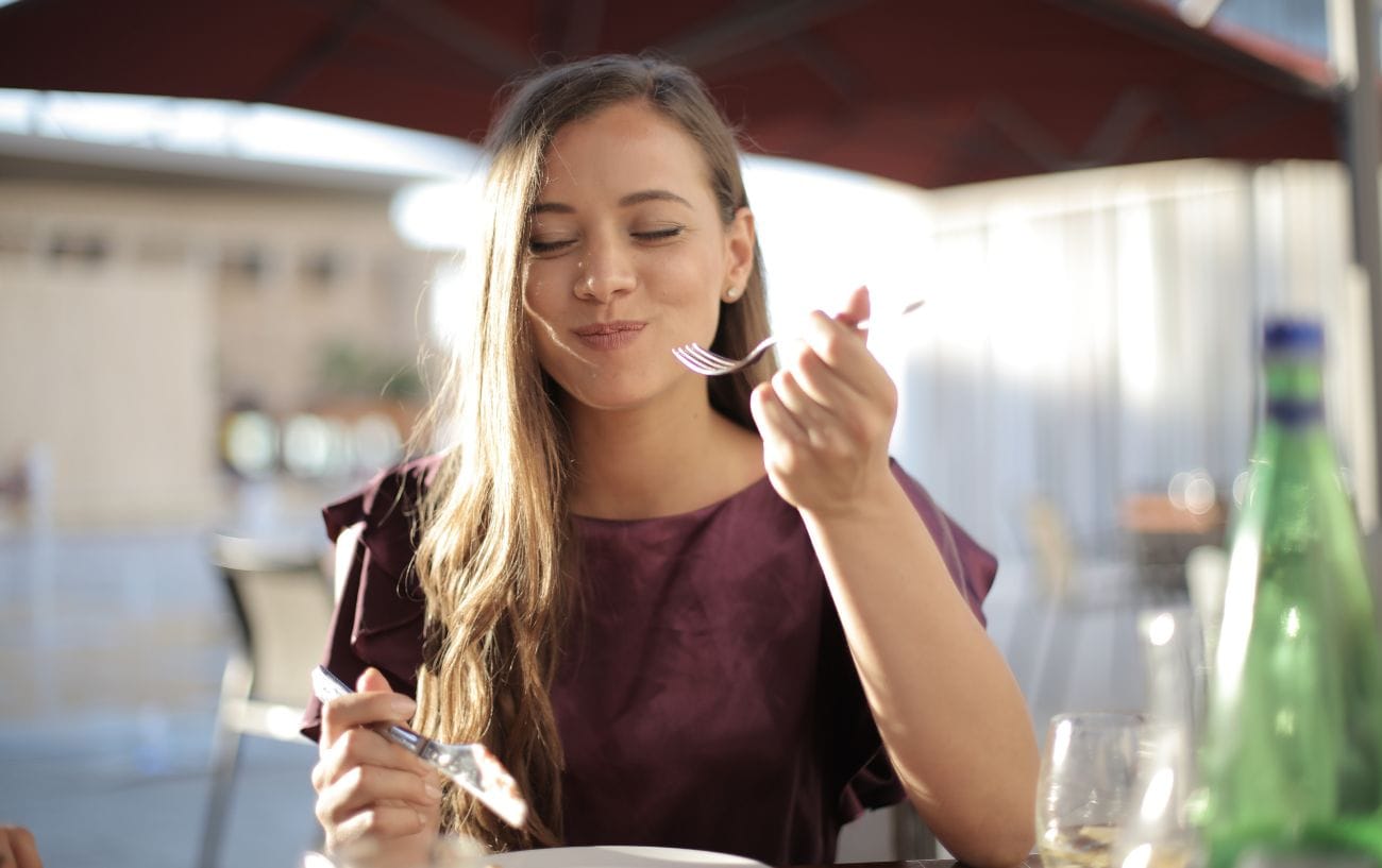 A person eating and smiling.