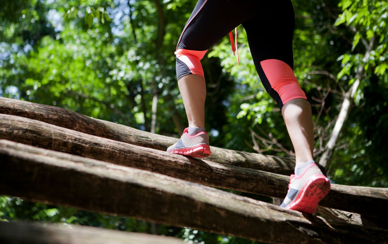 A person climbing up logs.