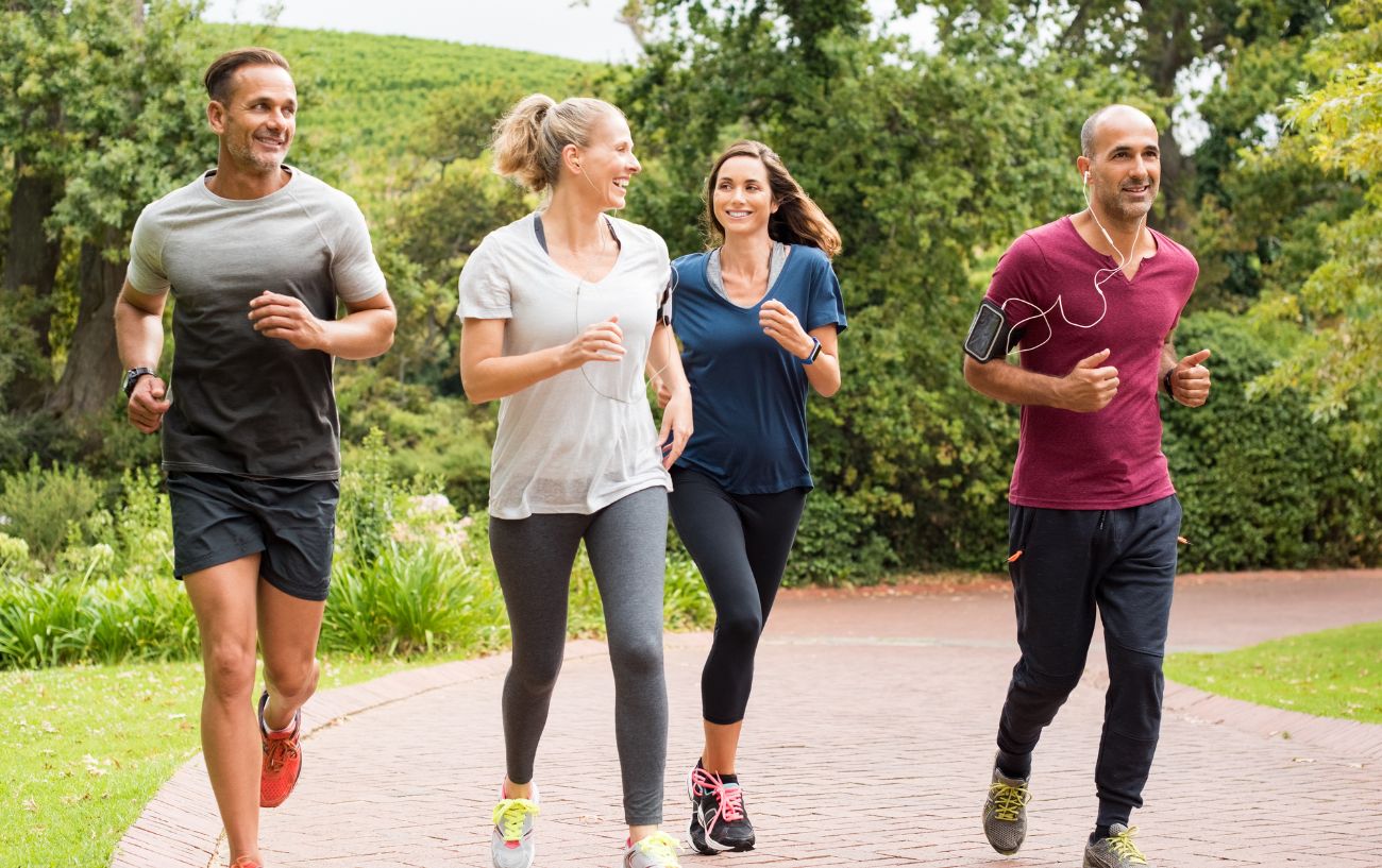 A group of friends go for a run along a trail.
