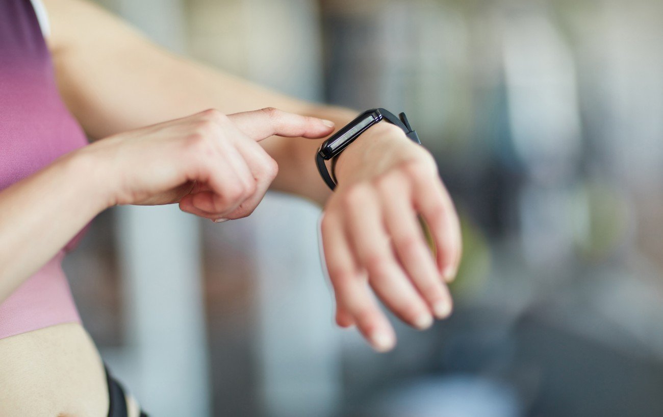 A person pointing at their training watch.