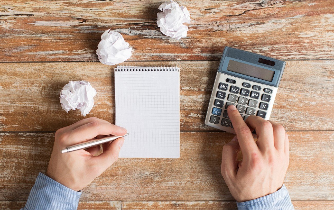 A person with a calculator and a notebook.