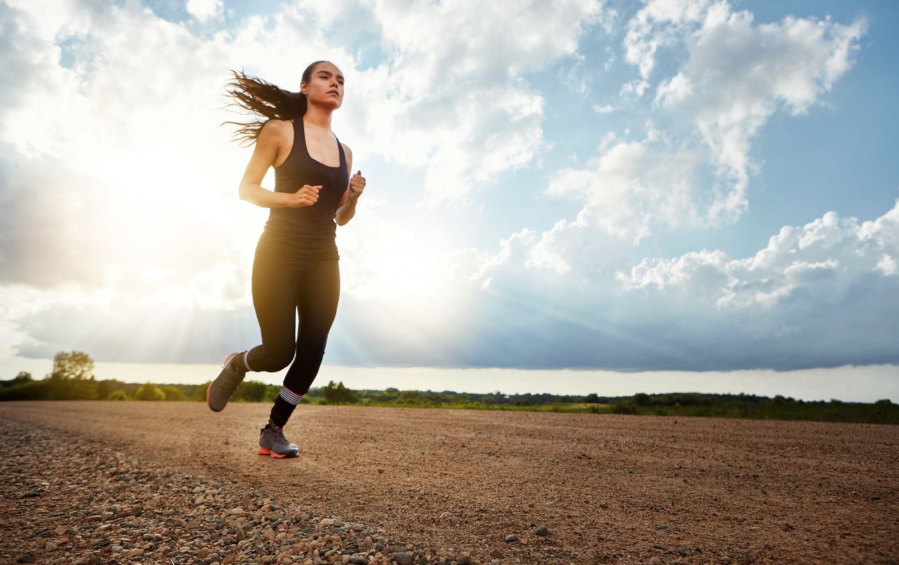 A person running on arid ground.