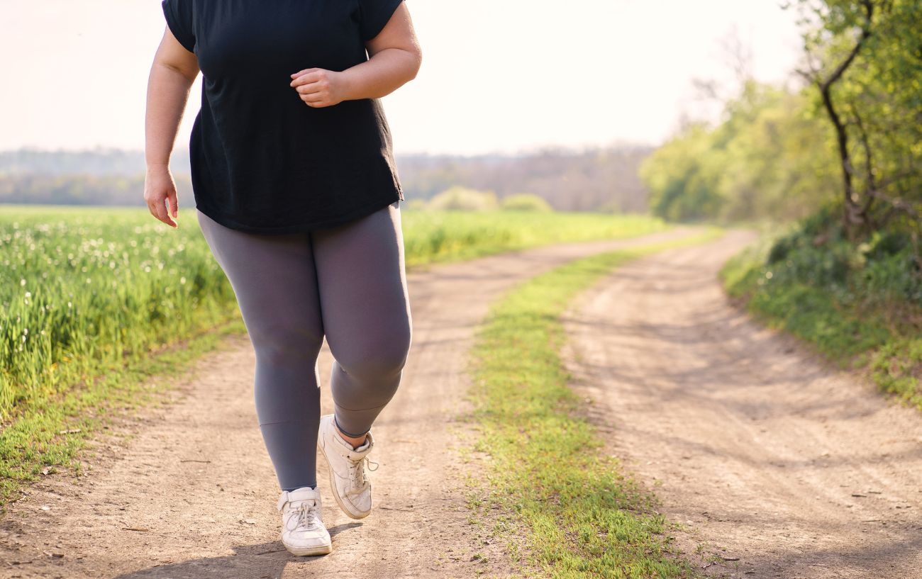 An overweight person jogging.