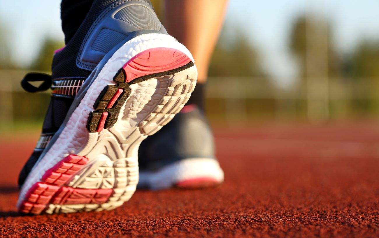 A person stepping onto a track.