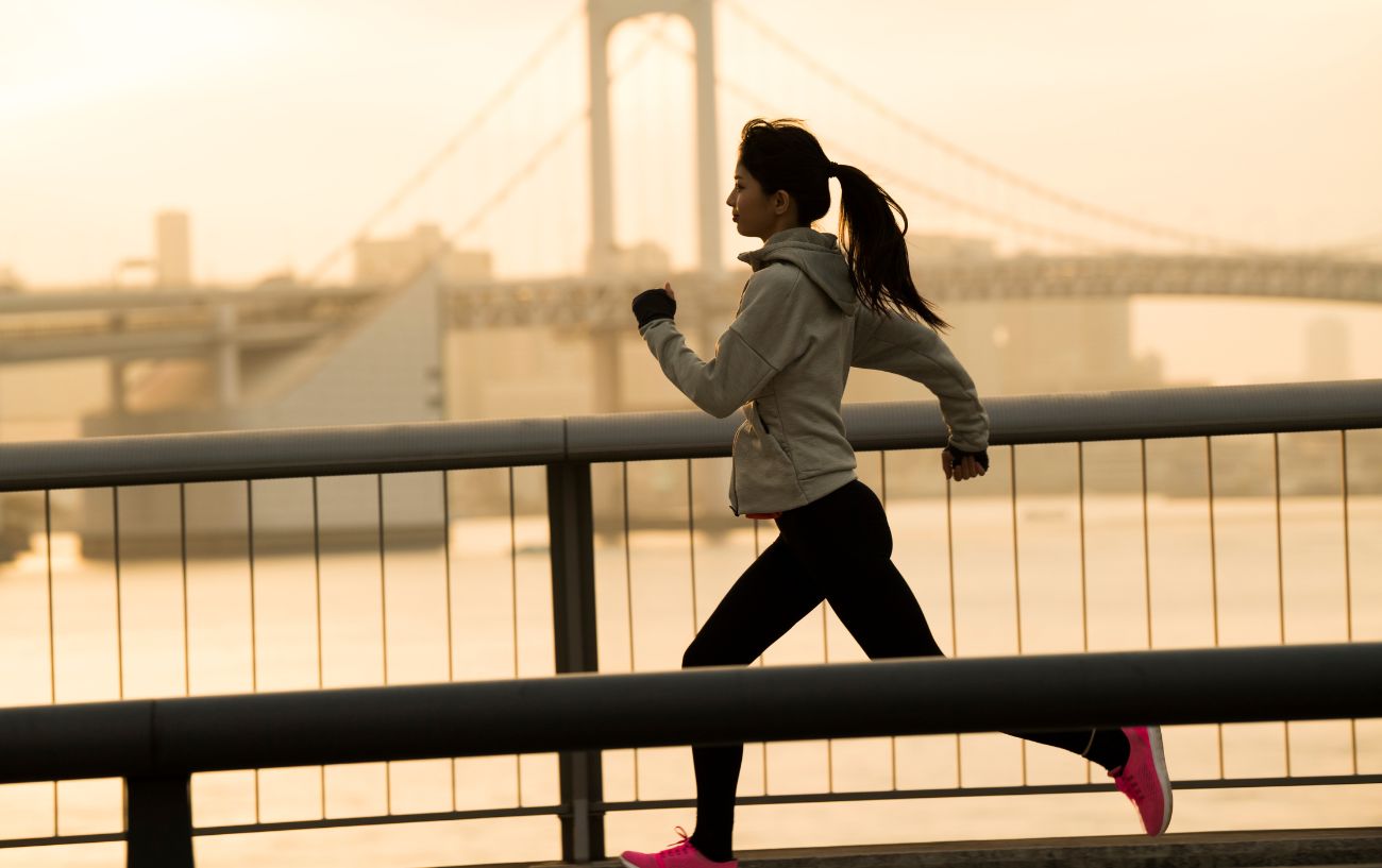 A person running over a bridge.