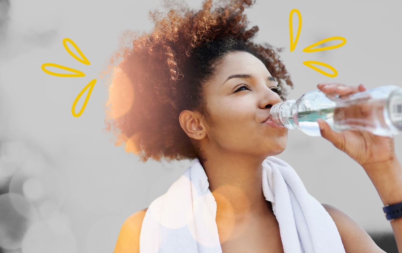 a woman drinking water from a bottle