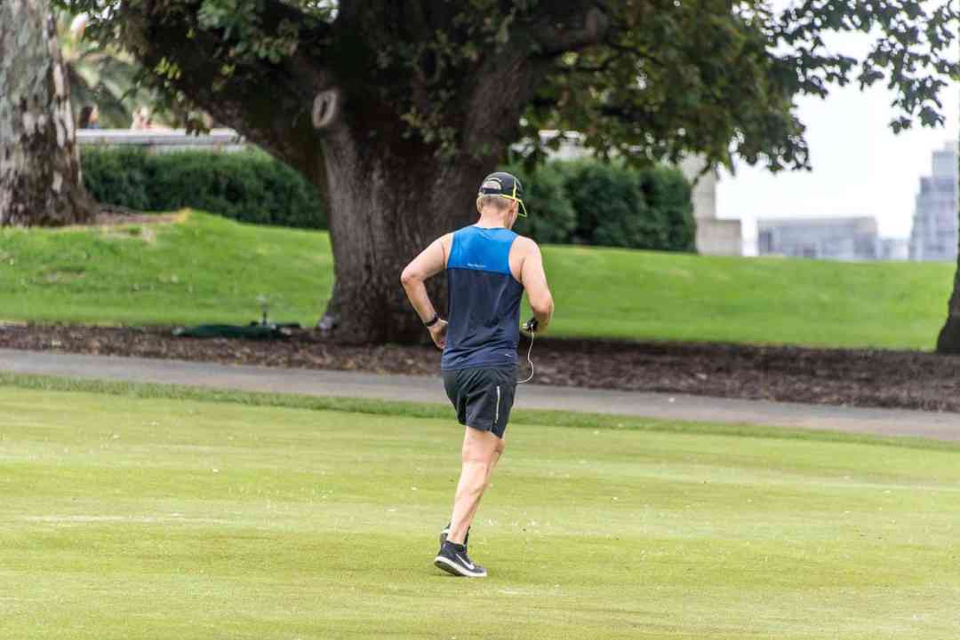 a man running on a grass field