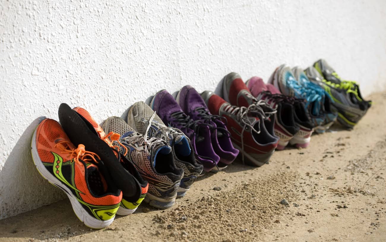 A running shoe rotation with several pairs lined up.