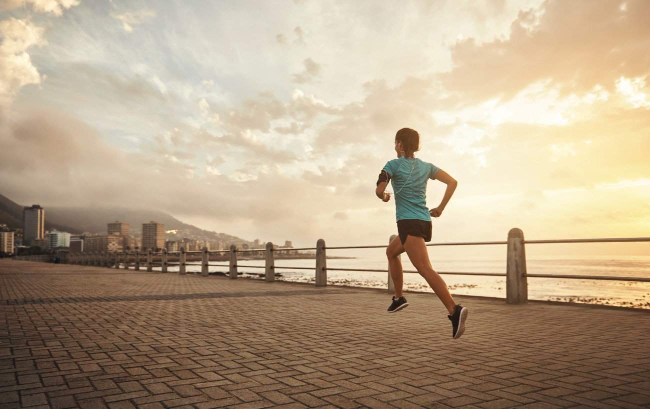a woman running on a brick walkway